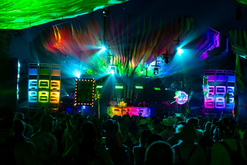 The Woogie stage glows in rainbow colors late at night.