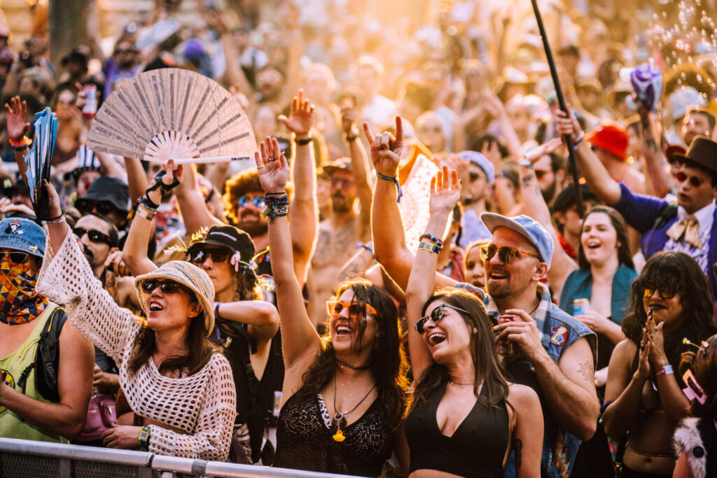 Patrons enjoying themselves at a set at Hulaween during the sunset