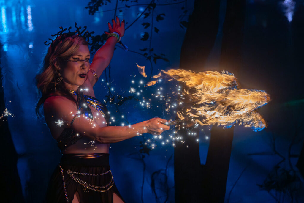 fire performer wielding a fire start at Hulaween, josh skolnik 