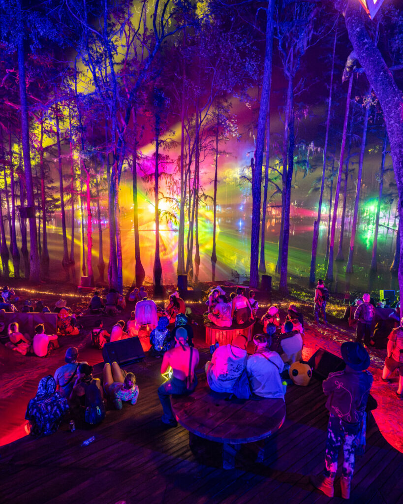 colorful photo of crowd and trees at hulaween in 2024, preparing for hulaween 2025