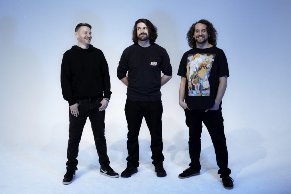 studio image of the band members of Sunsquabi, shot with a blue blackdrop, Hulaween 2025 Ele tric Feels Exclusive Inverview